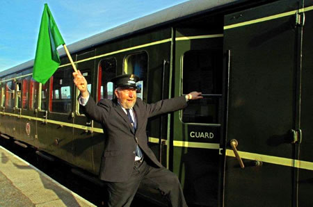 Guard waving green flag to DMU driver